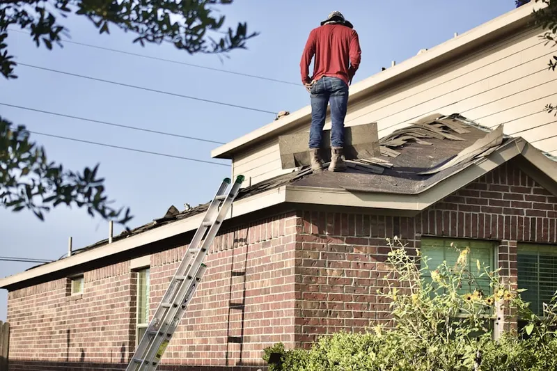 Professional roofer working on a residential roof in Kidwiler Park